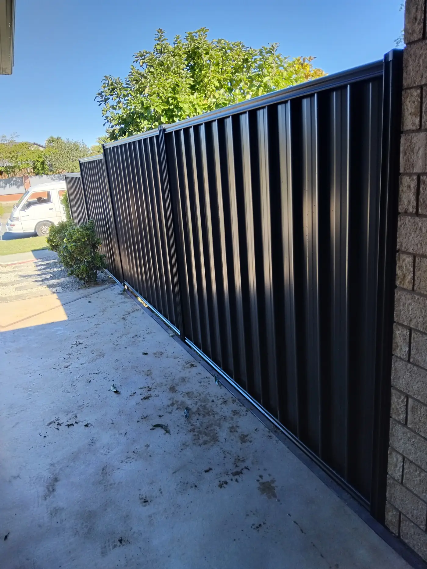 Black metal good neighbour fence with sliding gate, Kaiapoi